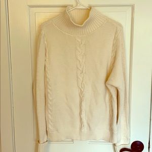 Cream colored turtleneck cable knit sweater